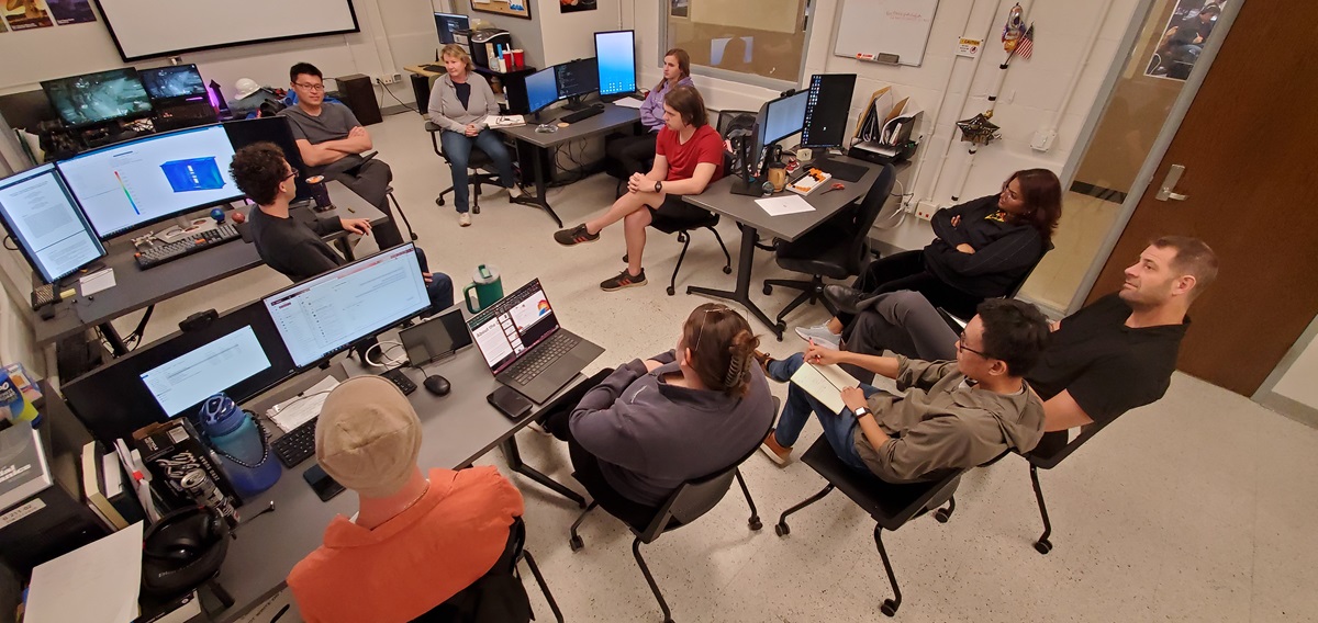 A one of the weekly Laboratory for Advanced Space Systems at Illinois meeting in the Steven R. Nagel Mission Operations Center in Talbot Laboratory, AE faculty members Vicki Coverstone, Matt Hausman, Xin Ning, and LASSI Laboratory Manager Murphy Stratton are seen meeting with students Phoenix Alpine, James Helmich, Hongrui Zhao, Ben Ochs, Michael Harrigan and Nitya Jagadam.