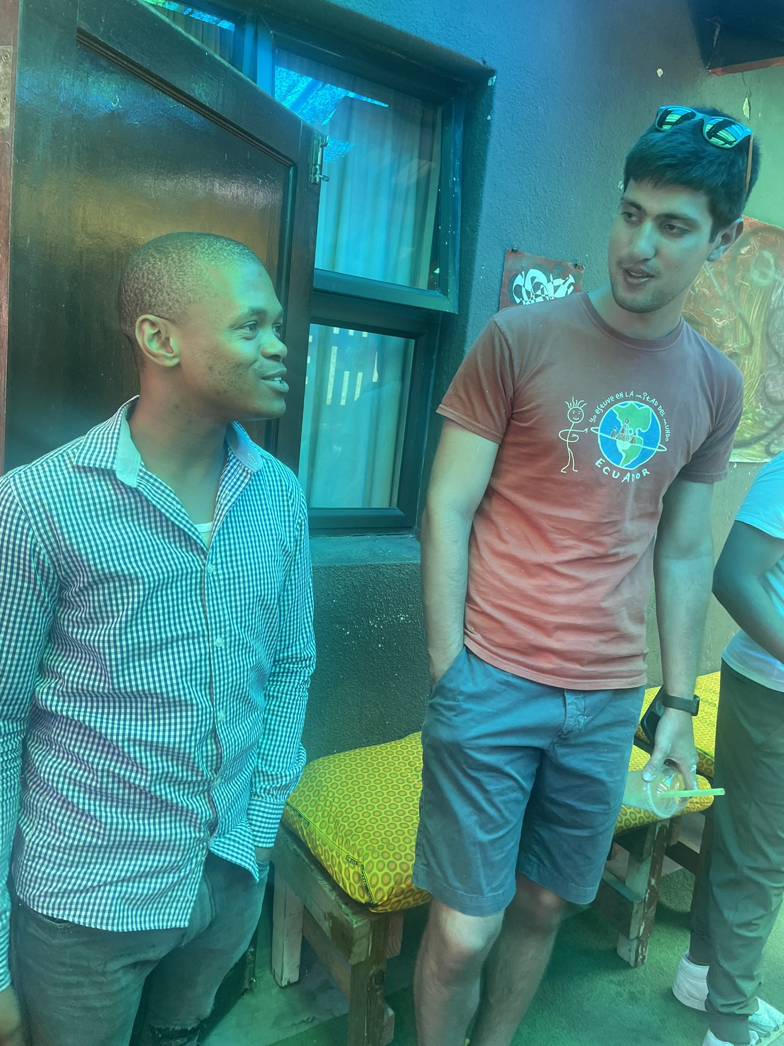 Zolfaghari having a conversation with coffee shop owner in South African Township, 2024