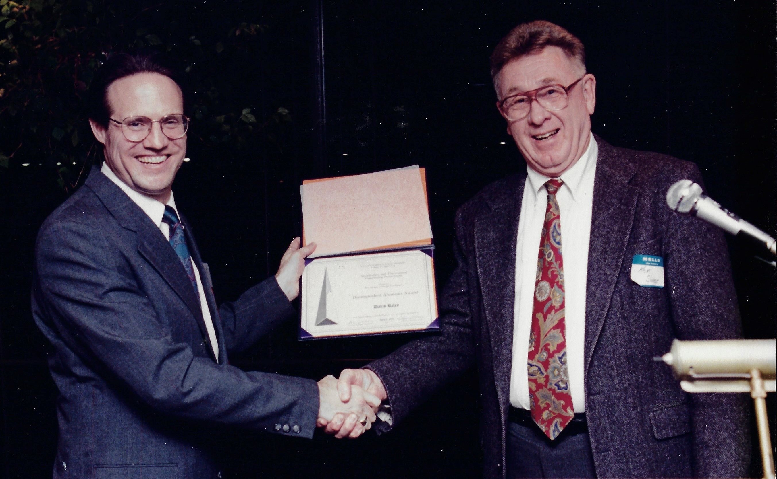 Dave Riley being presented with the Distinguished Alumni Award from faculty member Ken Sivier.