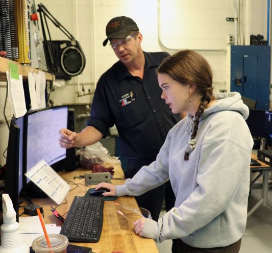 Dustin Burns with Ashley Sawa in the student machine shop.