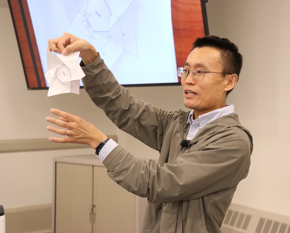 Professor Xin Ning demonstrating origami folds in his new space structures class.