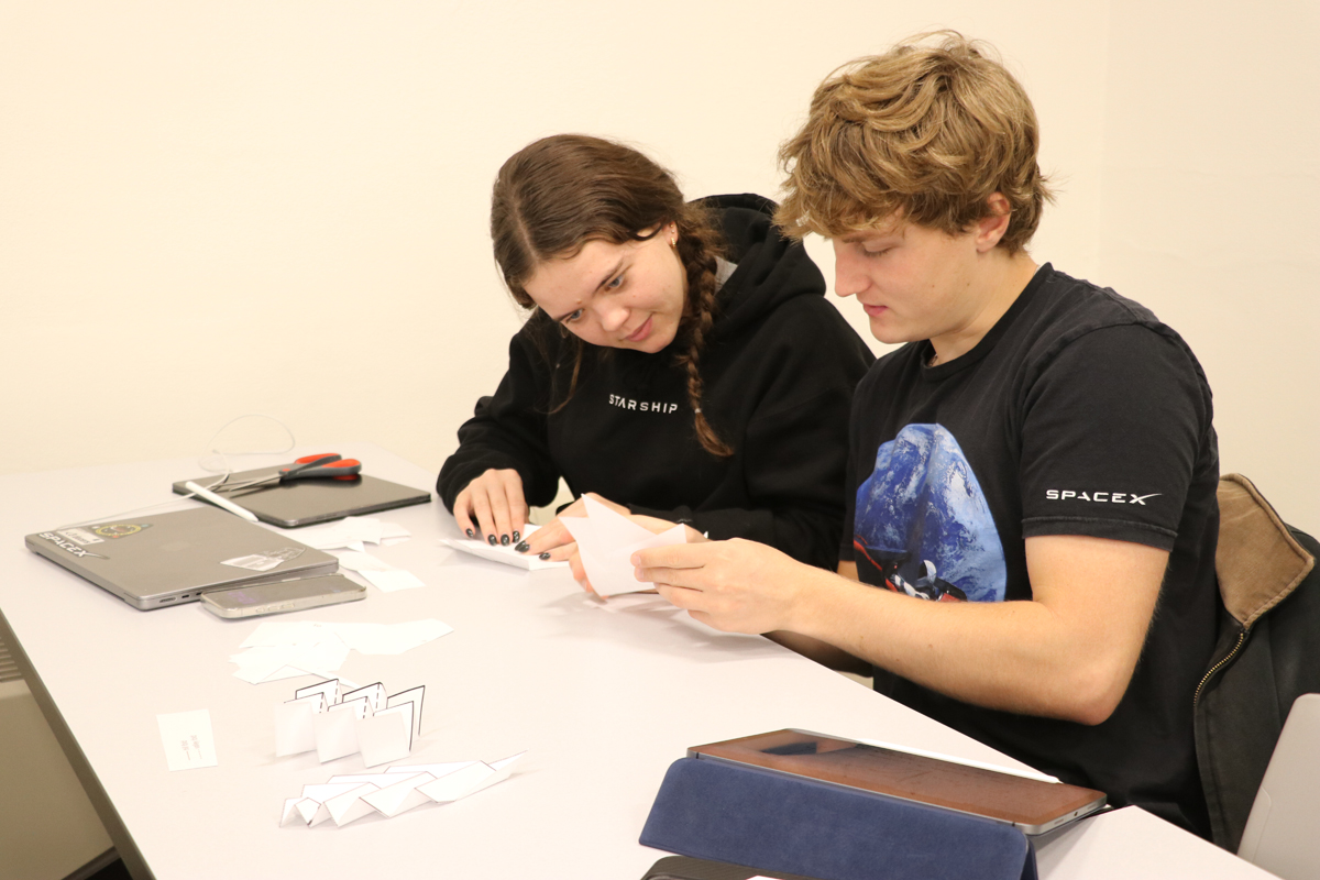 students working together on origami project