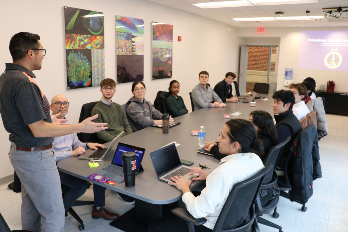 Joseph Gonzalez opens a review session with Jose Corral and Ed Chainani from The Grainger College of Engineering Office of Safety and members of the Liquid Rocketry Initiative, including seated around the conference room table Anika Bansal, Leo Ma, Maxwell Mullarkev, Margot De La Torte, Mariano F. Rodriguez, Zachariah Dahhan, Hannah Kurien, Thomas Folan, Vincent S. Kim and Ari Frost.