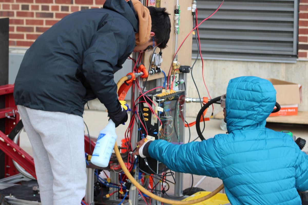 Nikolaos Monogyios and Dhruva Chowlur working through test procedures that were reviewed during the Liquid Engine Water Flow Test Readiness Review. This phase of the test involved pressurizing the system and verifying that any leaks exceeding an established allowable limit were identified and addressed. Monogyios and Chowlur are locating the source of a leak using a bubble soap test&acirc;&euro;&rdquo;one of the few leak detection methods commonly used in industry for pressurized systems.