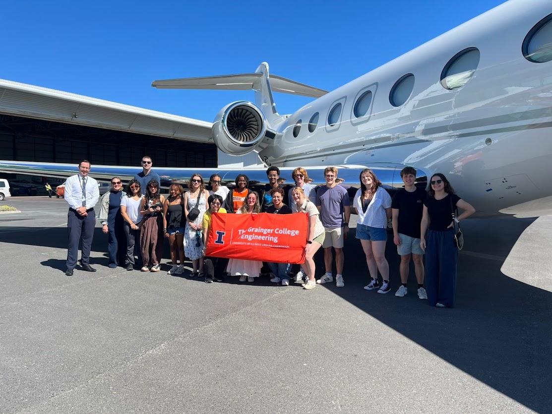 Grainger engineering students in front of an airplane in South Africa at ExecuJet.