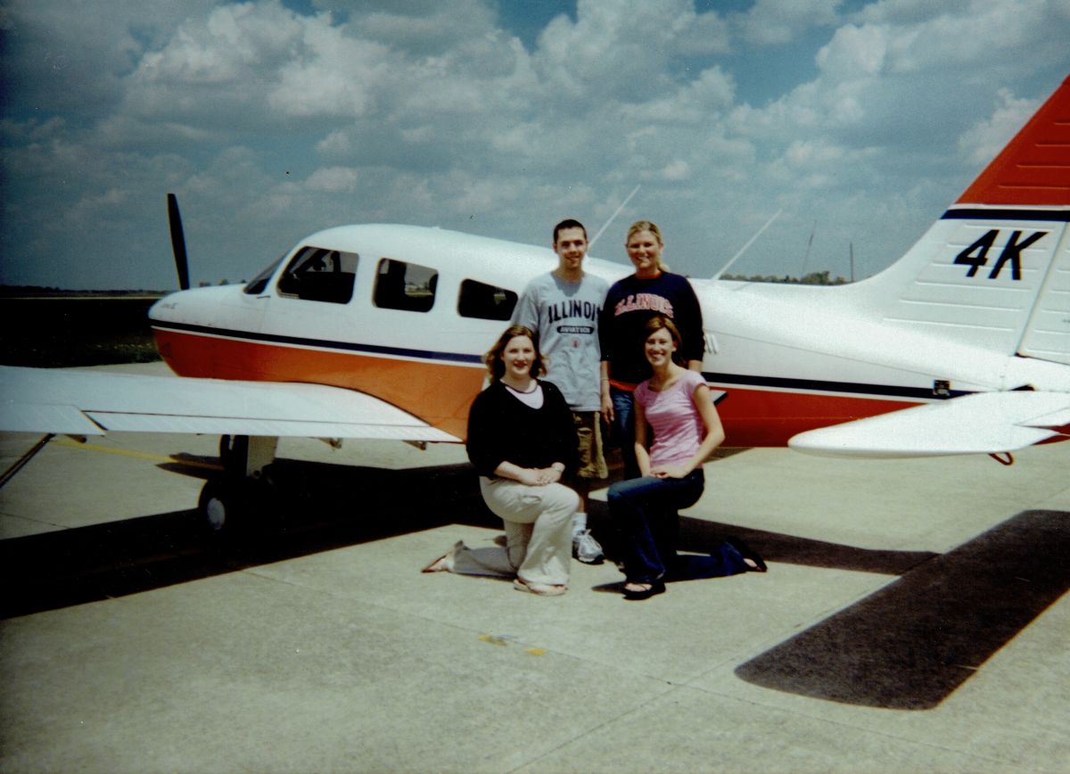 In an Institute of Aviation promotional photo, Kevin Irving and Blair Wilson in the back row, Laura Gerhold and Brittney Miculka in front.