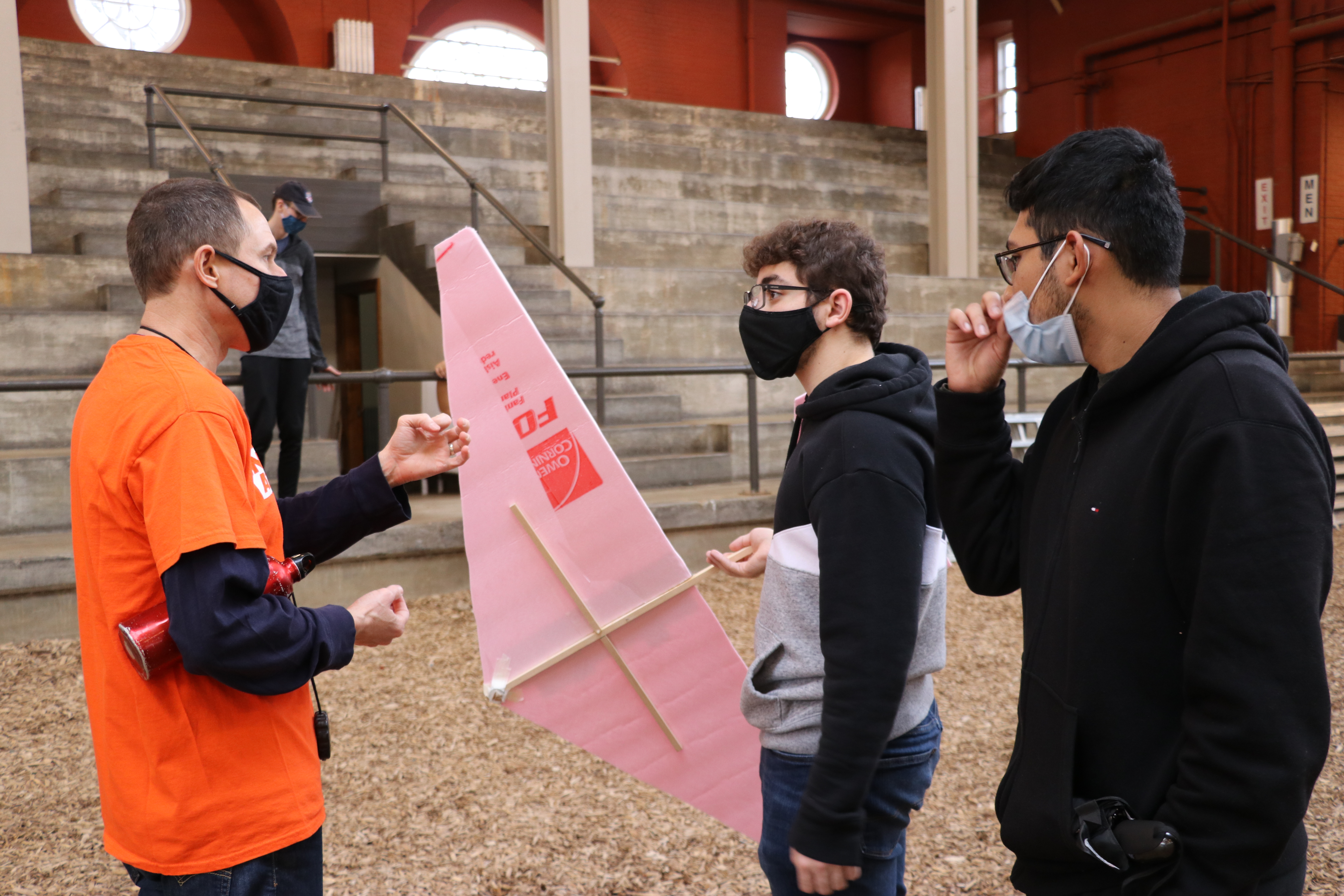 Woodard with students from AE 100 in the stock pavilion for their final glider projects.