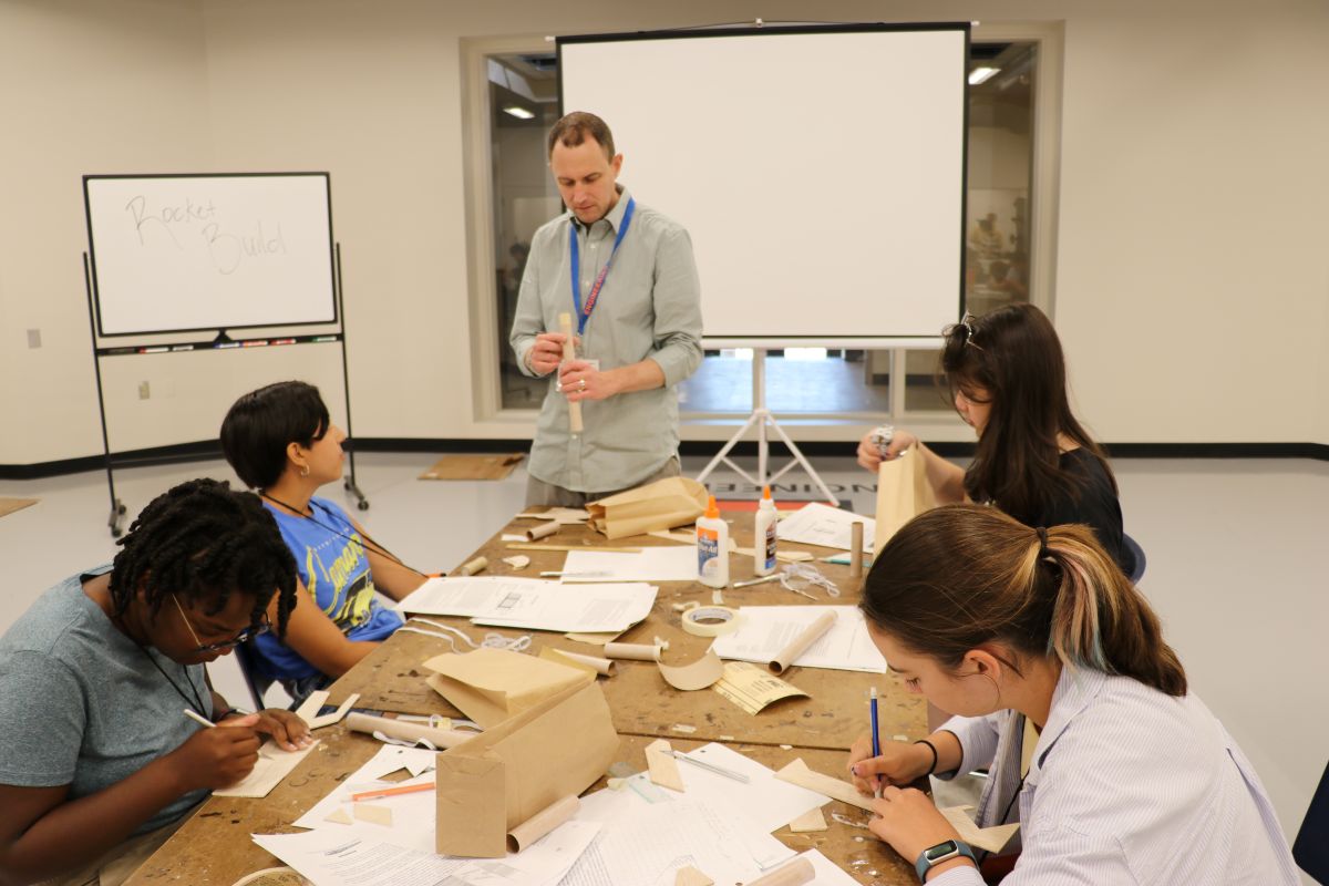 Woodard assisting students in an aerospace summer camp.