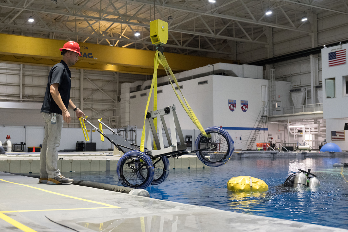 NASA government reference design tool cart used for testing is lowered into the Neutral Buoyancy Laboratory.