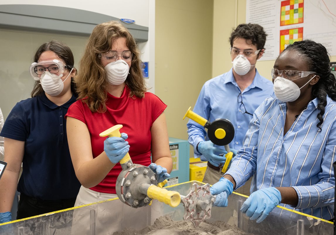 Test week team conducts lunar simulant testing on ATHENA in the Simulant Development Laboratory.