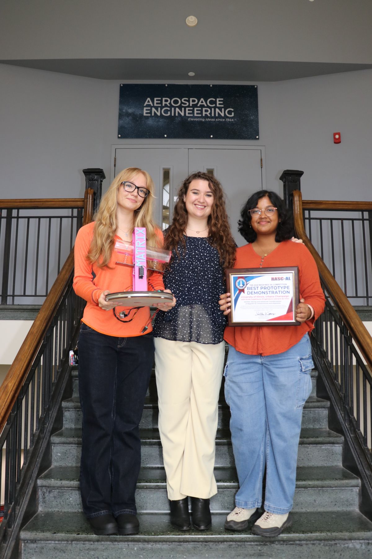 Left to right are Dasha Kediarova holding the prototype, team lead Hannah Speranza, center and Suhani Verma, holding the award. Kediarova and Verma built the prototype to demonstrate at the NASA competition.