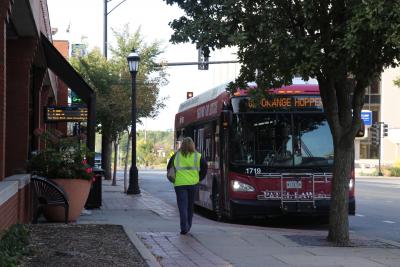 Orange route MTD bus waits at the downtown Urbana stop.