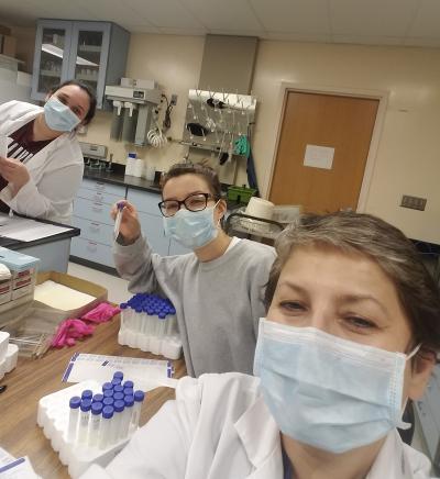 Left to right: SIUC graduate student Nita Shillova, U of I AE undergrad Zana Essmyer, and immunologist Vjollca Konjufca prepare vials with viral transport media for COVID-19 tests.