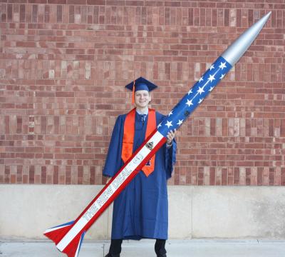 Ryan Noe holding the first high-power rocket he helped build and paint with the Illinois Space Society for the 2017 NASA Student Launch Competition. 