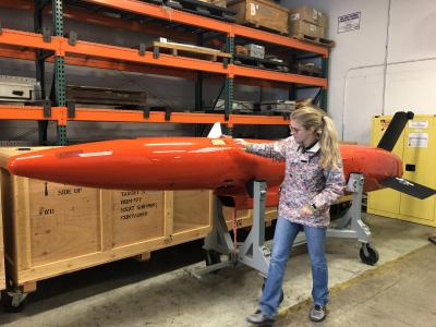 McCue inspects an unmanned aerial target in preparation for deployment to a test range for flight testing.