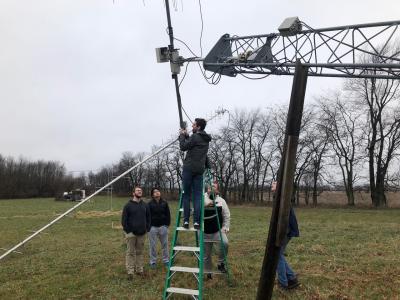 U of I engineering students Dillon Hammond, Rong Zhou Li, Adam Newhouse, Robert Maksimowicz, and Rick Eason inspect the ground station antenna in preparation for CubeSail mission operations. The ground station is located north of Urbana and will be used for sending commands and receiving telemetry from CubeSail.