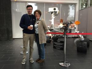 Patrick Drew with his mother Jacqueline Dourlet Drew posing with a rover at NASA's Jet Propulsion Laboratory
