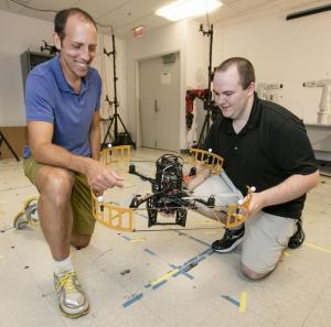 Tim Bretl, left, and a student in Bretl's robotics lab.