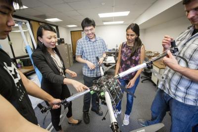 Grace Gao and her students working with a UAV.