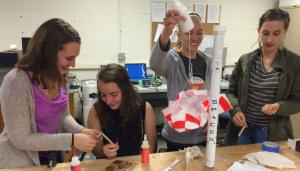 Members of the Women in Aerospace working on a rocket project.