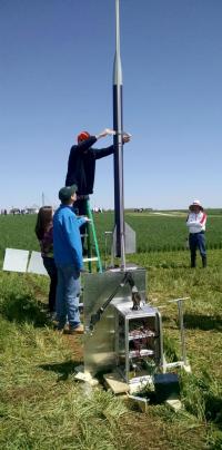 A team member prepares the rocket for flight.