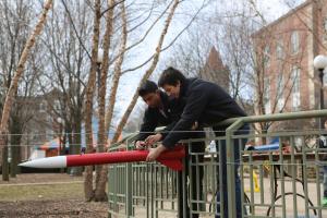Members of the American Institute of Aeronautics and Astronautics student group ready rockets to race.