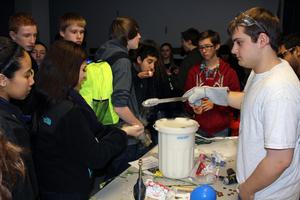 An AE student serves up frozen marshmallows.