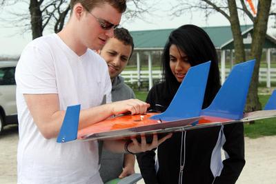 Aerospace at Illinois students inspecting their UAV.
