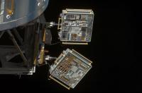 MISSE-6 experiments attached to the International Space Station, orbiting above the earth.