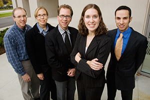 U. of I. researchers have improved a self-healing process originally described in 2001. In the new repair process, solvent-filled microcapsules that are embedded in an epoxy matrix rupture when a crack forms. The new solvent is non-toxic and less expensive. Researchers: from left, Jeffrey Moore, a professor of chemistry; Nancy Sottos, a professor of materials science and engineering; Scott White, a professor of aerospace engineering; and graduate research assistants Mary Caruso and Benjamin Blaiszik.