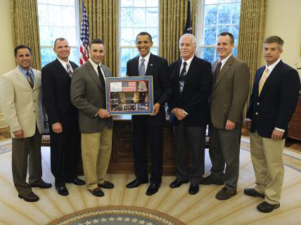 NASA's STS-119 space shuttle crew, including AE alumnus Lee Archambault, third from the left, present President Barack Obama with a montage in the Oval Office of the White House on Friday, May 1, 2009, in Washington, D.C. Other crew members were, from left, Joseph Acaba, Tony Antonelli, John Phillips, Richard Arnold and Steve Swanson.