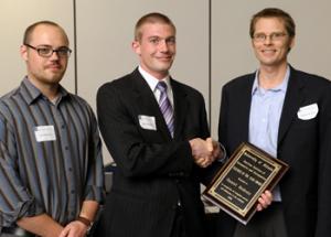 From left, Joel Houston and Ryan Palmer, 2009-10 and 2010-11 presidents, respectively, of the American Institute of Aeronautics and Astronautics student chapter, present AE Assistant Prof. Daniel J. Bodony with the AE Teacher of the Year Award.
