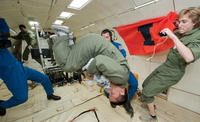 AE Undergraduate Erik Lopez testing an experiment in zero gravity while aboard the Weightless Wonder (aka, Vomit Comet).