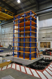 Figure 1: The 9-story structure on the shake table with NES devices installed