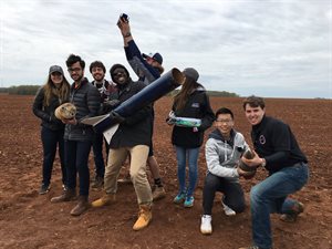 Javier Brown, center holding rocket, with the Student Launch Team at a competition in Alabama his junior year at Illinois.