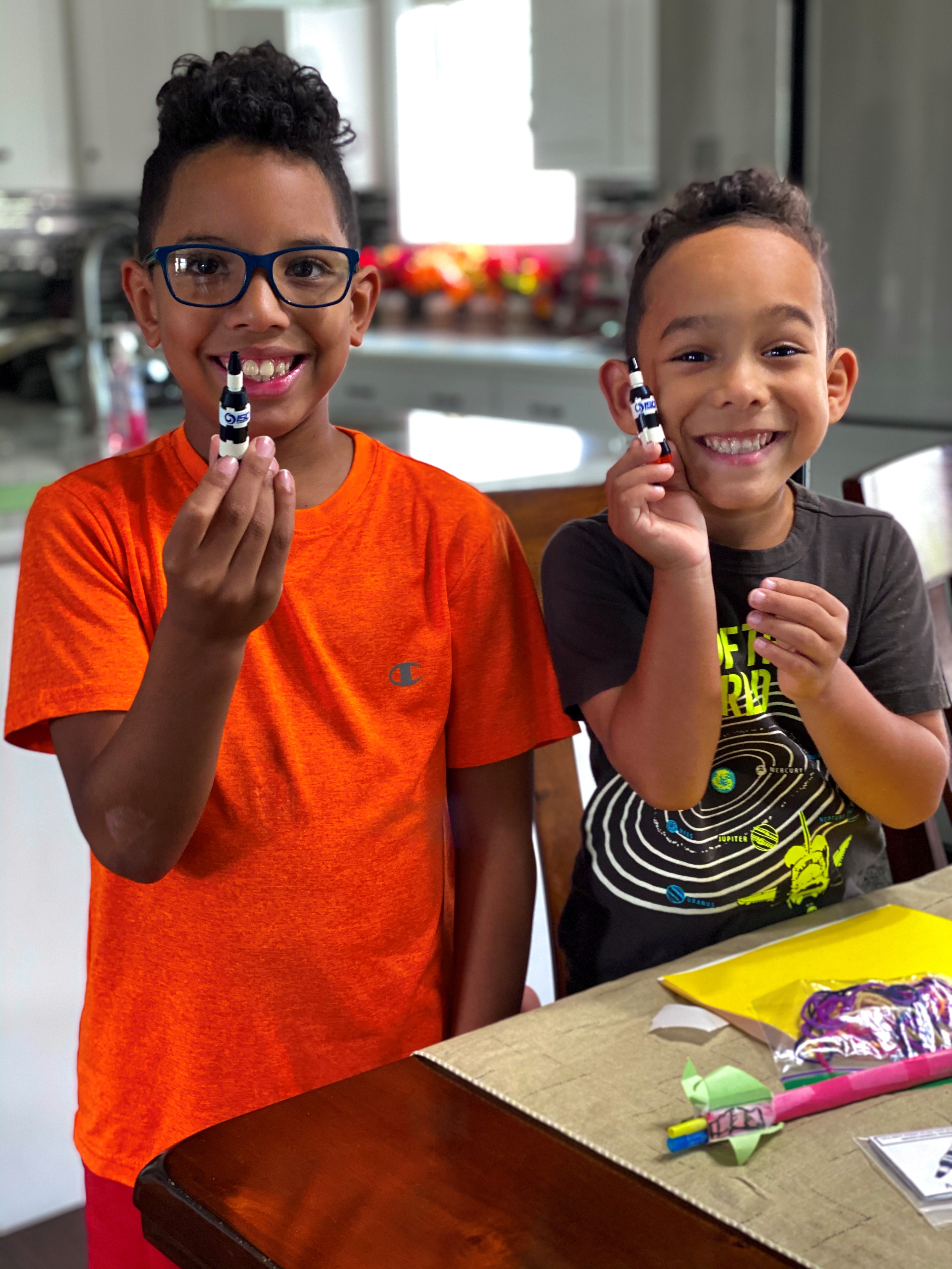 Participants, second grader Tanner and kindergartner Elijah show off their projects