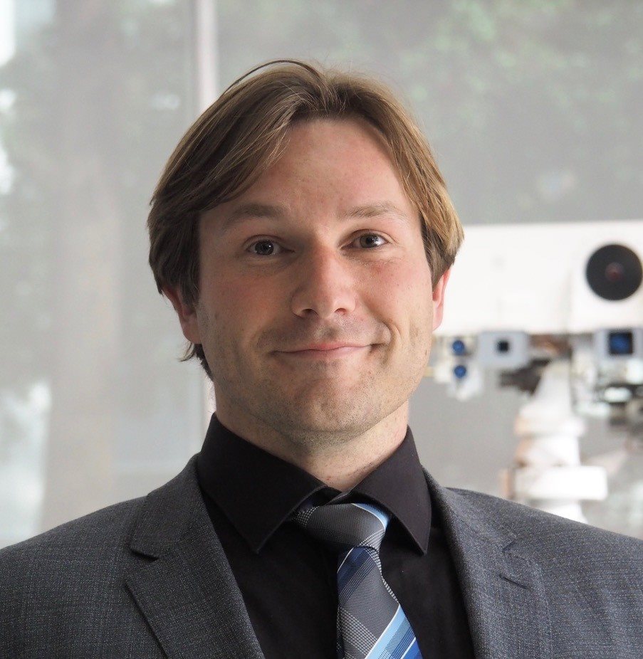 Siegfried Eggl headshot wearing a gray suit