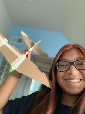 Emma Martinez holding the glider she created during camp.