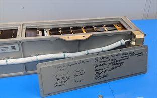 The Nanoracks CubeSat Deployer, which CAPSat was loaded into, has flown several missions in the past so the access panel has markings and signatures from the 2019 CubeSat SOCRATES, as well as the satellite that sits behind CAPSat for this launch, SPACE HAUC.  The signatures of Logan Power and Rick Eason can be seen directly underneath the UIUC Block I sketch.