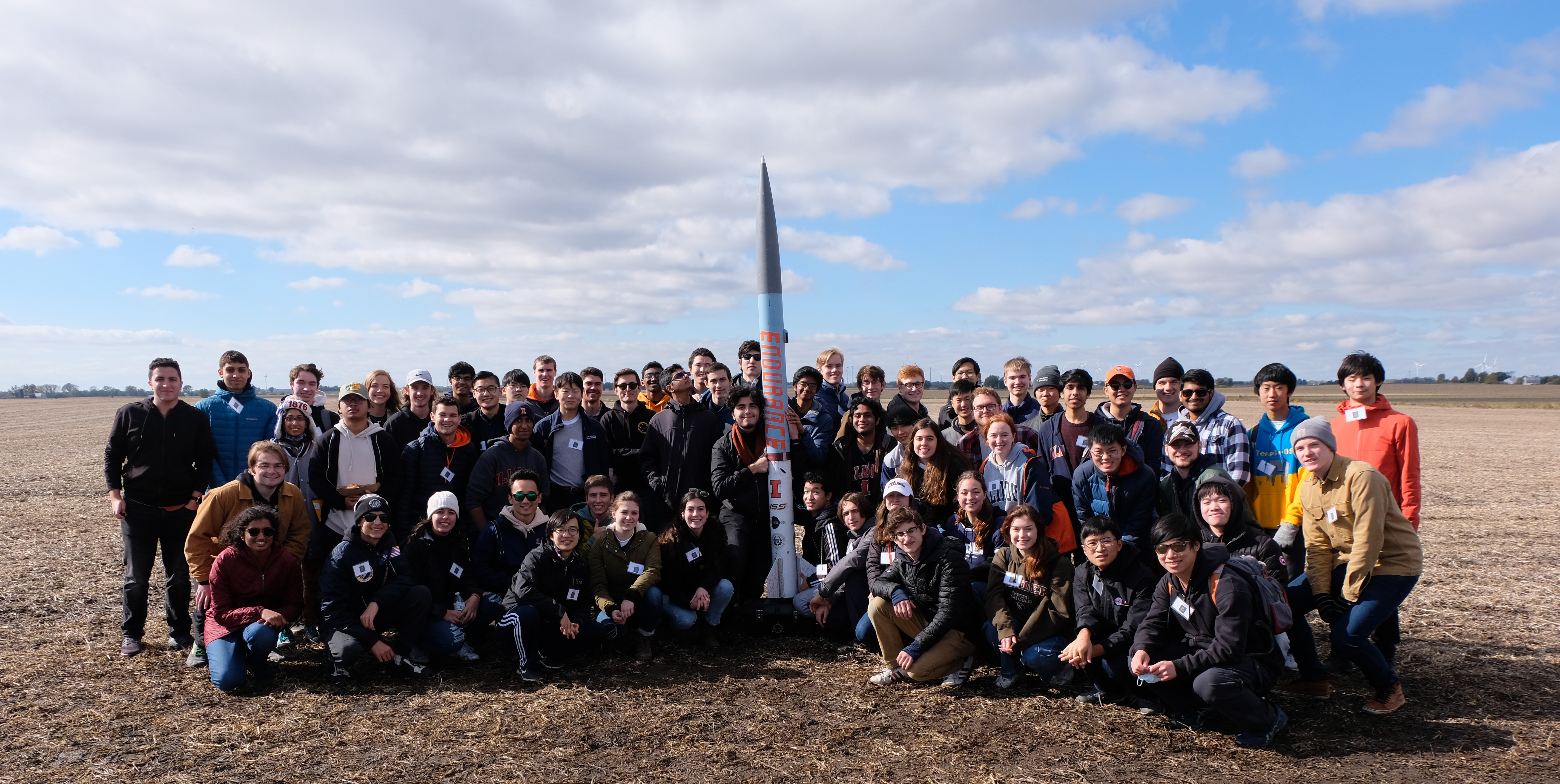 members of the launch team with rocket