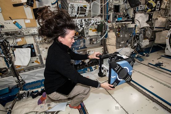  NASA astronaut and Expedition 65 Flight Engineer Megan McArthur sets up an Astrobee robotic free-flyer inside the International Space Station's Kibo laboratory module.