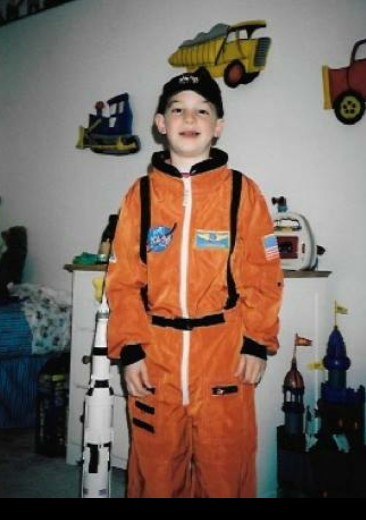 Daniel Engel wearing an astronaut flight suit when he was a child.