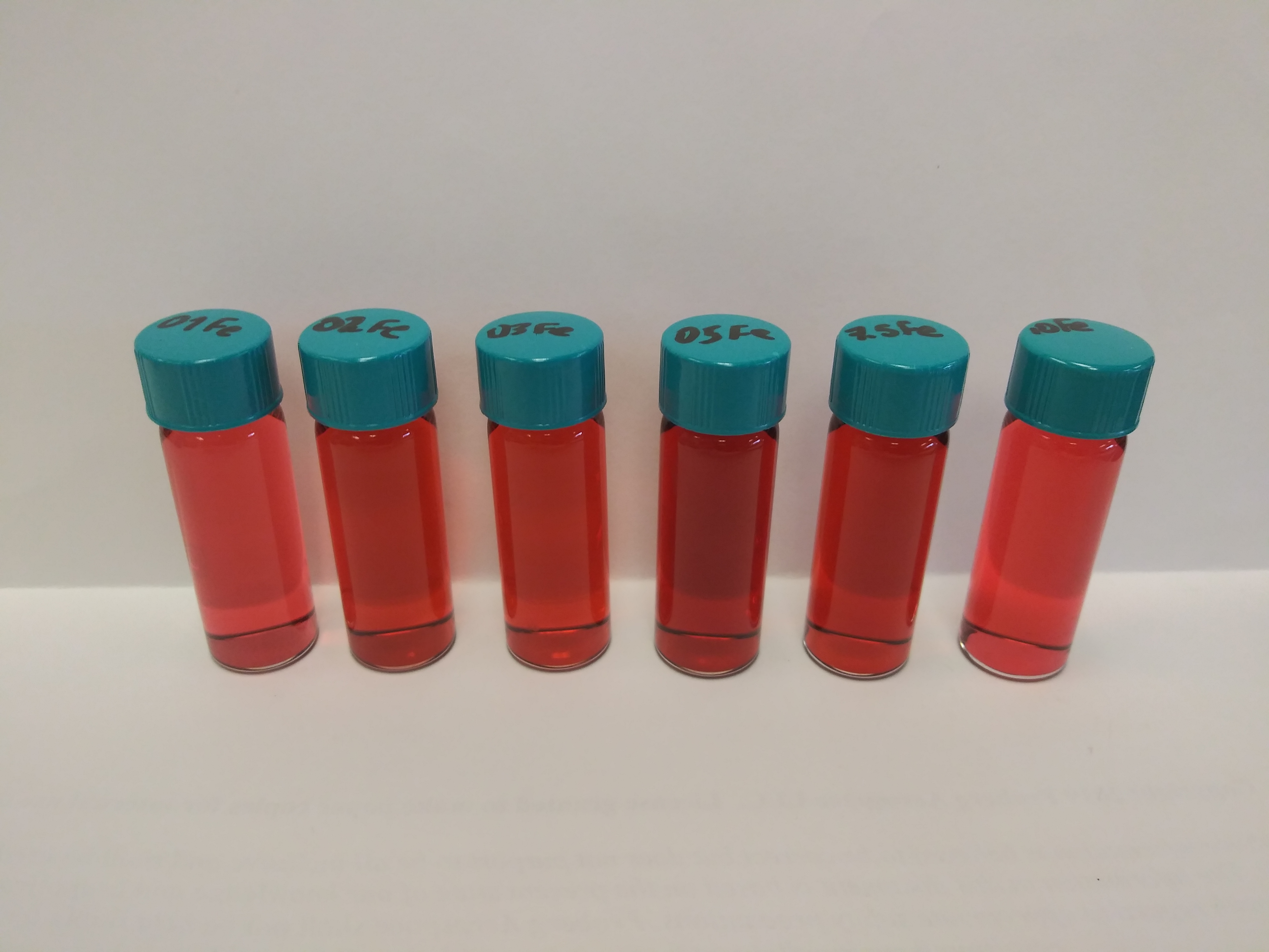 Samples with 100 ppm iron with 1, 2, 3, 5, 7.5, and 10 times as many moles of Bipy added respectively, from left to right in HNO3 solution.