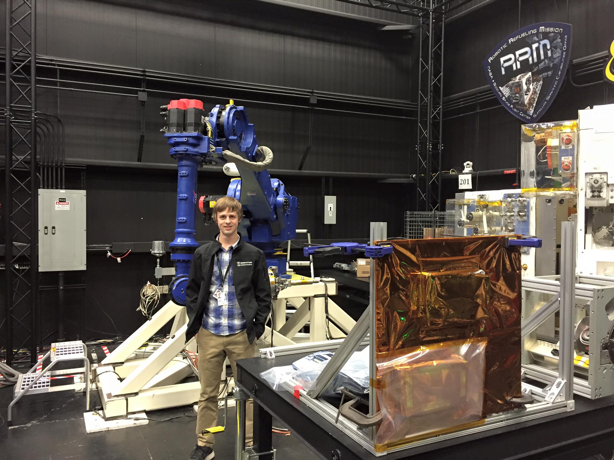 Macenski with large blue manipulator while working at NASA Goddard as a contractor