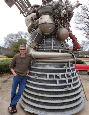 Daniel Dorney with J-2 engine (used on the Saturn V during the Apollo program) at Marshall Space Flight Center 