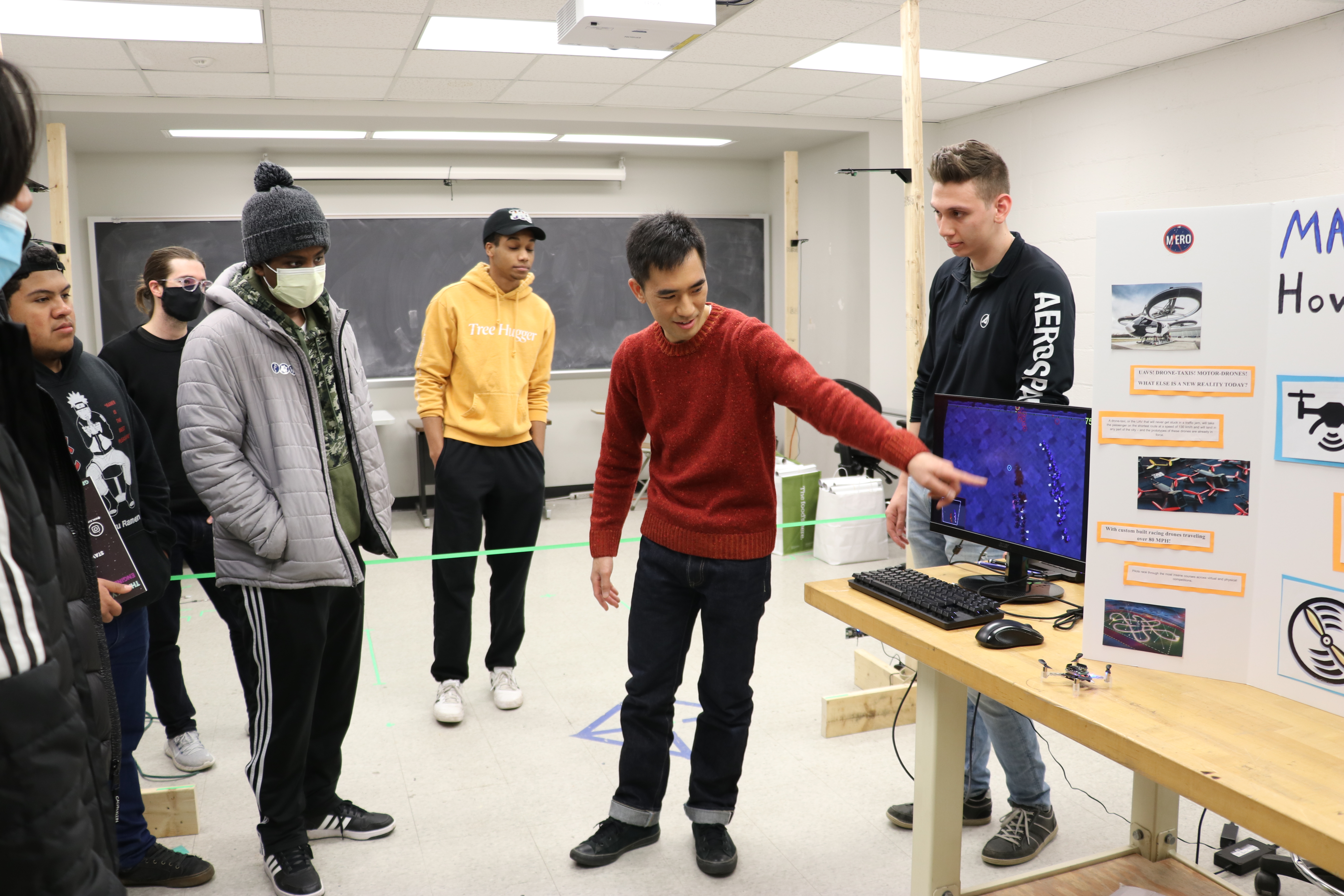 Huy Tran talks with students about his research at Enginering Open House.