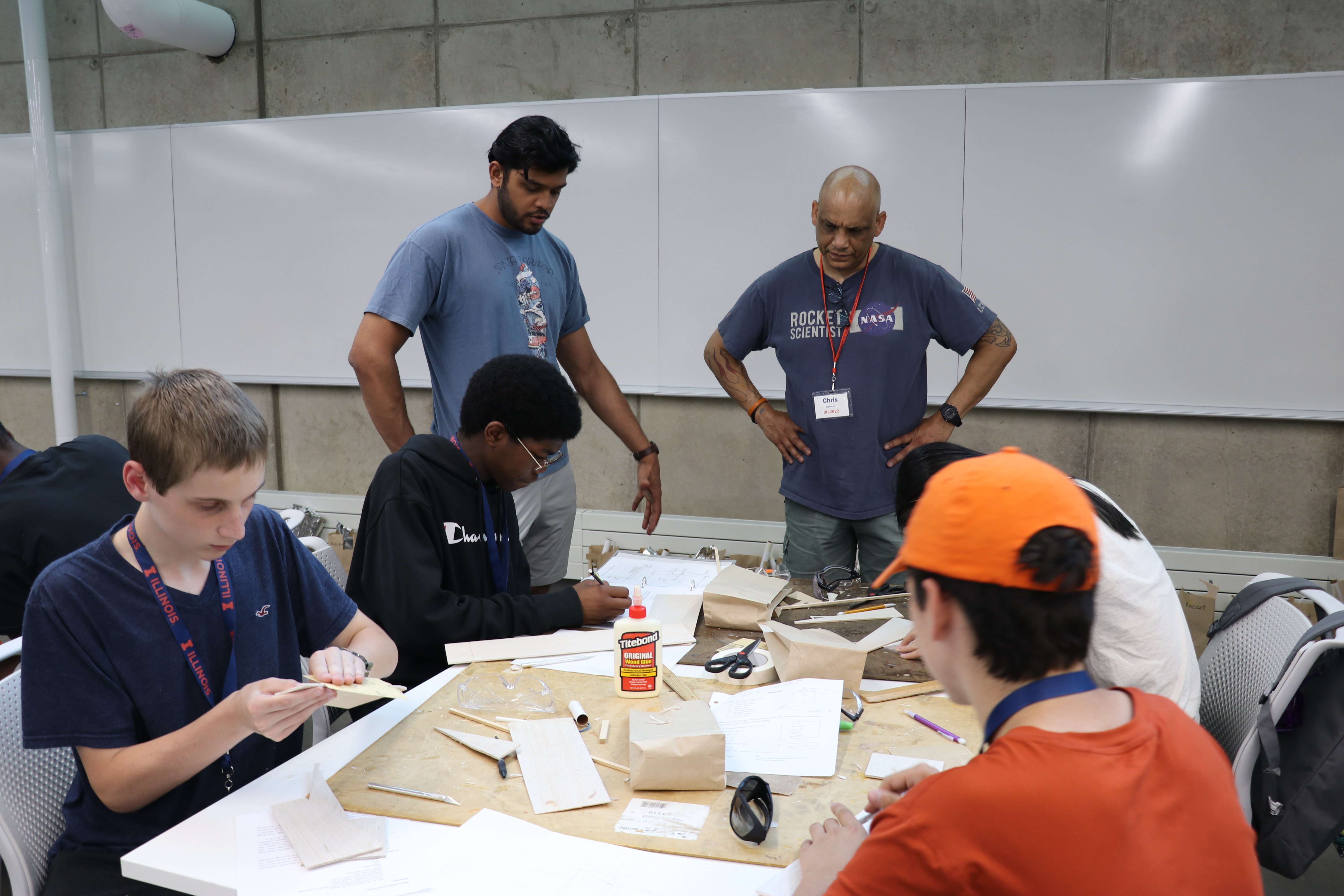 Young circulating to offer help to students at an Illinois Aerospace Institute rocket/glider build session.