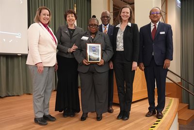 Mrs. Debra Carruthers, wife of the late Dr. George R. Carruthers, accepts a plaque on his behalf on Dec. 2 at the GLIDE renaming ceremony hosted by The Grainger College of Engineering. Photo Credit: University of Illinois   Left to Right: Dr. Susan Martinis, Vice Chancellor for Research and Innovation, Nicola Fox, Heliophysics Division Director, NASA, Mrs. Debra Carruthers, wife of the late George R. Carruthers, Robert J. Jones, Chancellor, University of Illinois Urbana-Champaign, Lara Waldrop, Carruthers Observatory PI, Y.T. Lo Fellow in Electrical and Computer Engineering, Rashid Bashir, Dean, The Grainger College of Engineering.