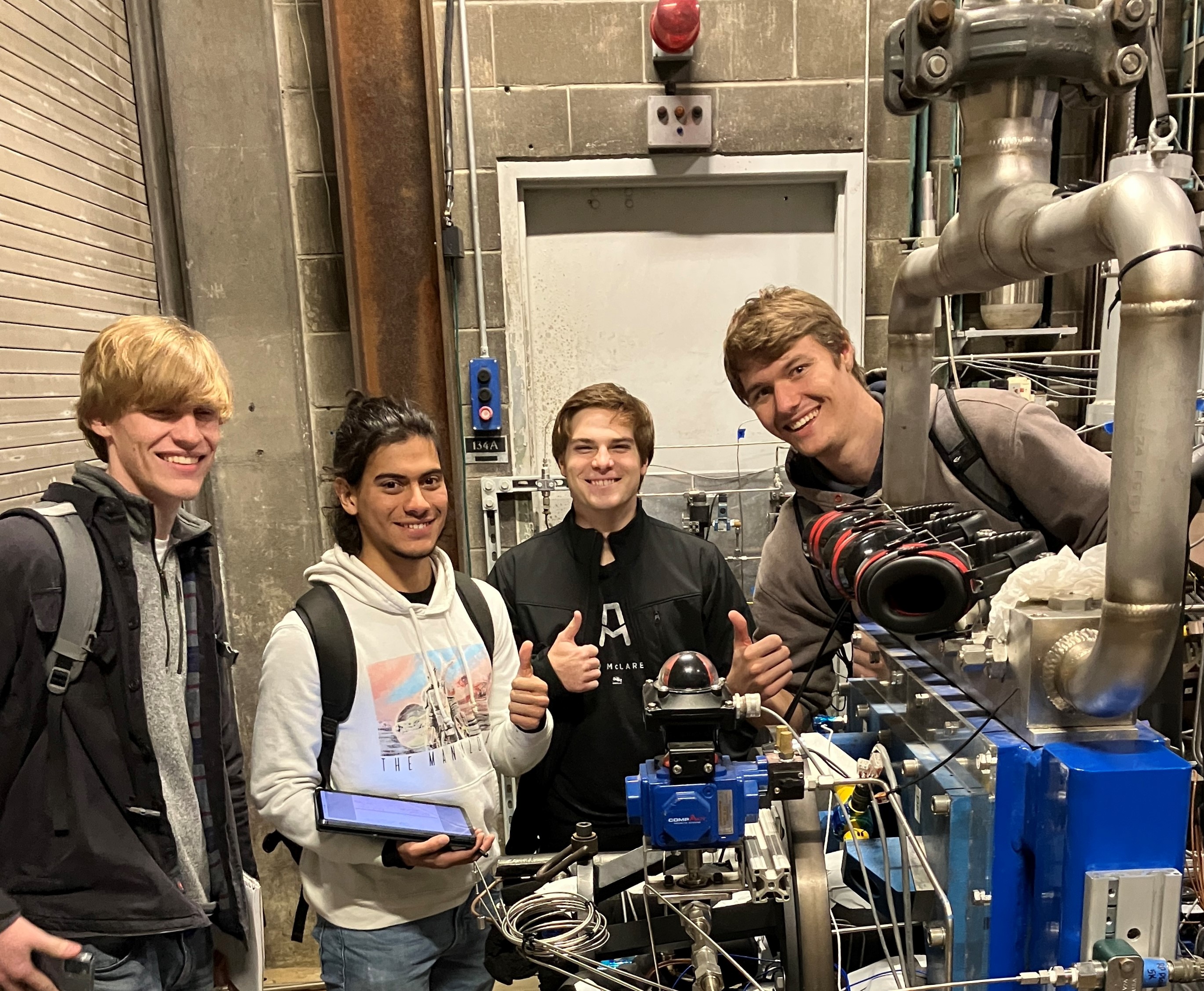 Team members visit Maurice J. Zucrow Laboratories to learn more about their test stand and safety. Left to right: Charles Cundiff, Santiago Zapata Zuluaga, Colin Reedy, and Bartosz Wielgos