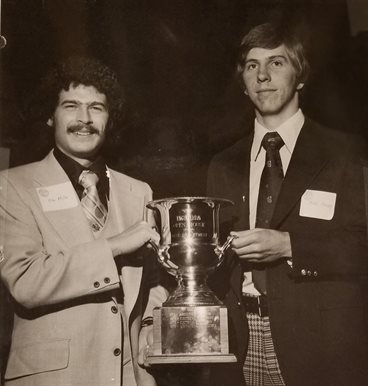 Michael Miller and Mike Bragg hold the Engineering Open House trophy for best department in 1976.